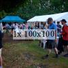 a communal space on the allotment with a marquee and gazebo and people around